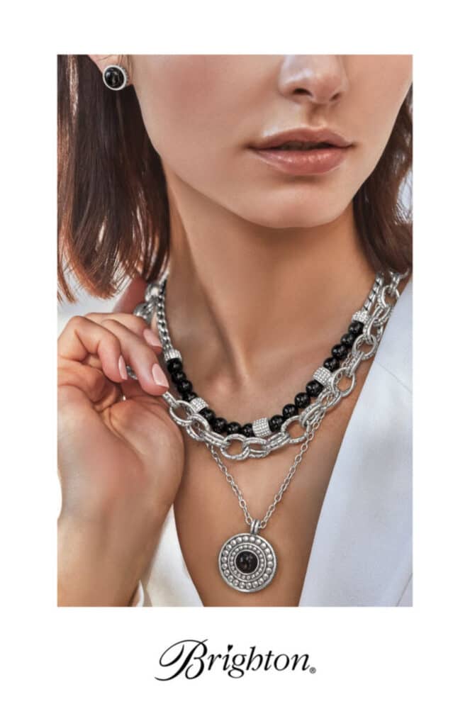 brighton fall catalog cover 2023 - woman holding silver necklace