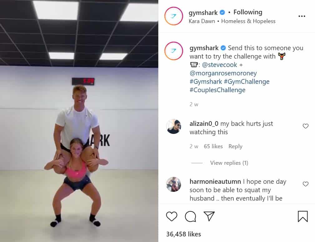 Girl doing a squad with guy on her shoulders.