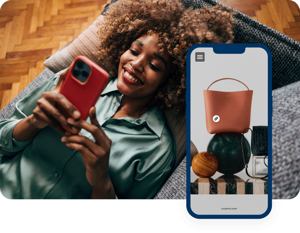 Woman relaxing on a couch while shopping on a phone.